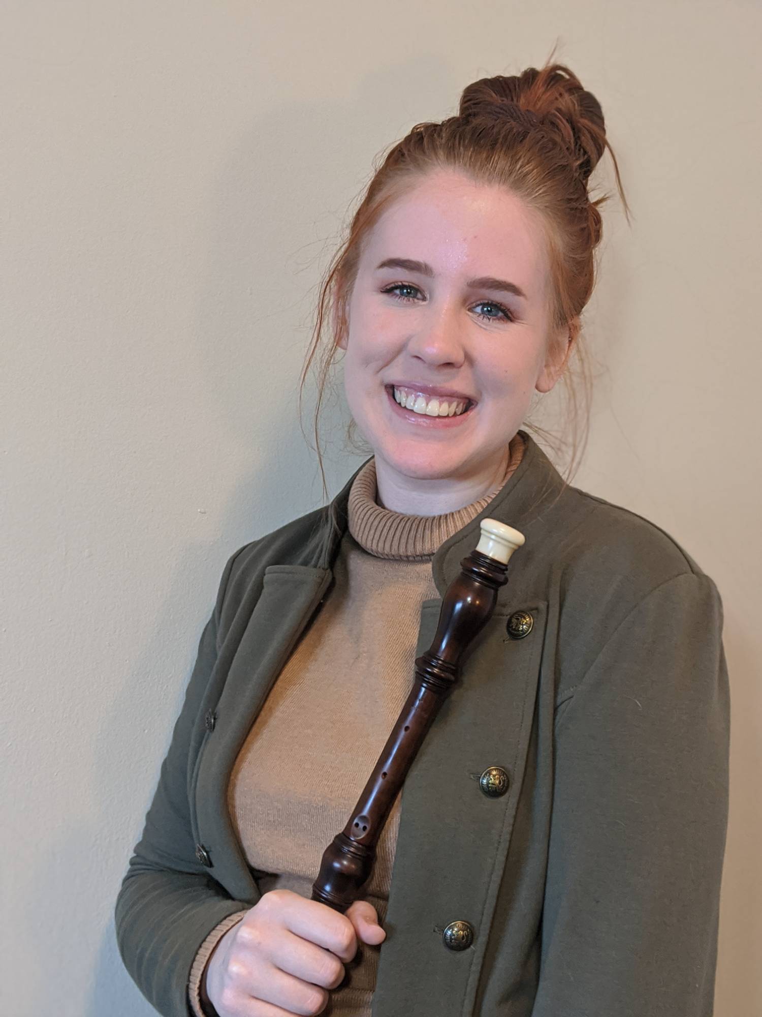 Emily Walker holding her Baroque oboe.